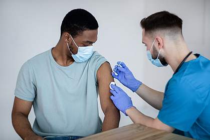 Black man with face mask getting immunized Black man with face mask getting immunized