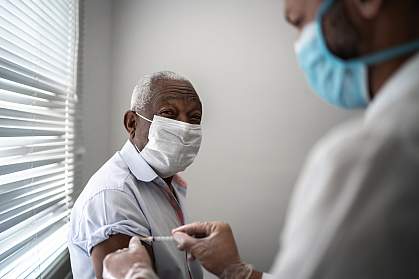 Mature black man getting vaccination Mature black man getting vaccination