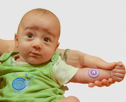 Baby with sweat sticker on arm Baby with sweat sticker on arm