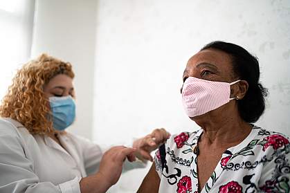Older Black woman getting a vaccination Older Black woman getting a vaccination