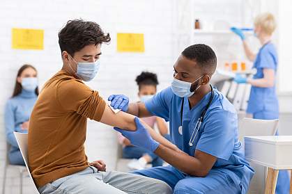 Asian male patient getting vaccinated against coronavirus in hospital Asian male patient getting vaccinated against coronavirus in hospital