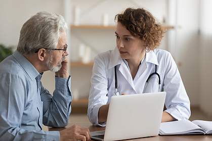 Female doctor speaking to older male patient Female doctor speaking to older male patient