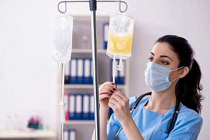 Doctor preparing bag of blood plasma for patient Doctor preparing bag of blood plasma for patient