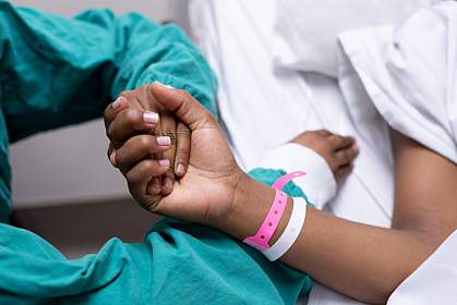 Photo of a doctor holding a patient’s hand Photo of a doctor holding a patient’s hand