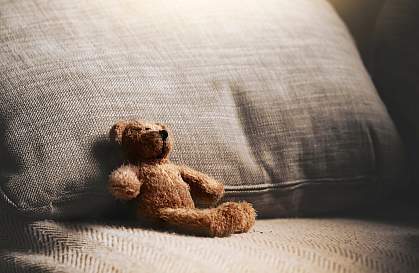 Teddy bear sitting alone on couch Teddy bear sitting alone on couch