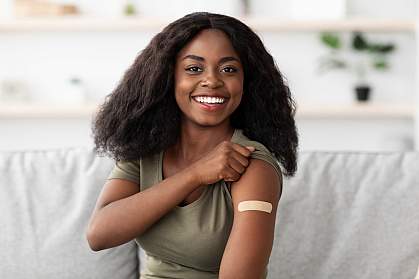 Young black woman with bandage from vaccination Young black woman with bandage from vaccination