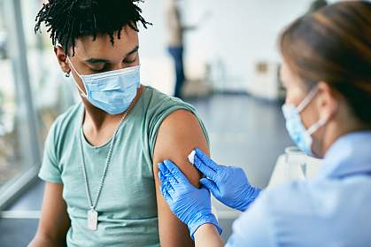 Young Black man getting vaccinated at vaccination center Young Black man getting vaccinated at vaccination center