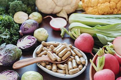 Fiber capsules in a bowl surrounded by fibrous vegetables Fiber capsules in a bowl surrounded by fibrous vegetables