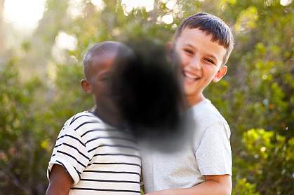 Two children obstructed by black splotch in center.