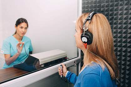 Audiologist doing a hearing exam on an older woman Audiologist doing a hearing exam on an older woman