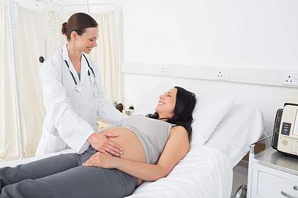 Female doctor with a pregnant woman in an examination room Female doctor with a pregnant woman in an examination room