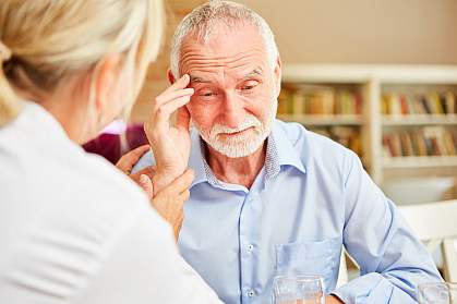 Senior man comforted by female doctor Senior man comforted by female doctor