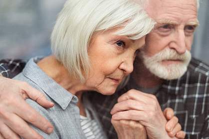 Senior man and woman holding hands and leaning close to each other Senior man and woman holding hands and leaning close to each other