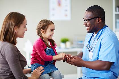 Small child and doctor talking in clinic Small child and doctor talking in clinic