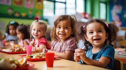 Group of AI-generated preschoolers sitting in the school cafeteria eating lunch. Group of AI-generated preschoolers sitting in the school cafeteria eating lunch.