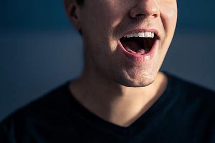 Close-up photo of the mouth of a man singing Close-up photo of the mouth of a man singing.