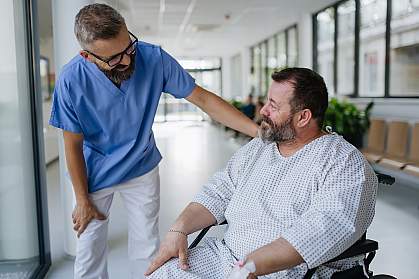 Doctor talking with an overweight patient in a wheelchair Doctor talking with an overweight patient in a wheelchair.