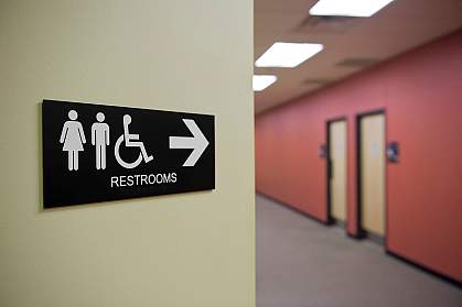 Bathroom sign on the wall of a hallway. Bathroom sign on the wall of a hallway.