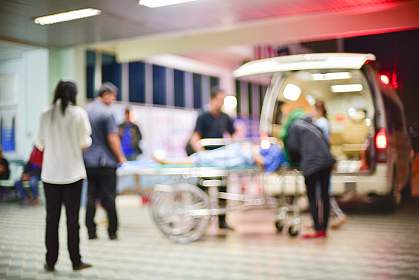 Blurred photograph of a patient being transferred from an ambulance. Blurred photograph of a patient being transferred from an ambulance.
