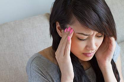 Woman holding her head in pain. Woman holding her head in pain.