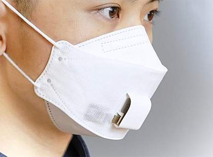 A woman wearing an EBCare smart mask. A woman wearing an EBCare smart mask, a paper mask with sensors in the area over the mouth.