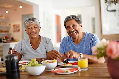 A happy older couple enjoying a healthy breakfast together at home. A happy older couple enjoying a healthy breakfast together at home.