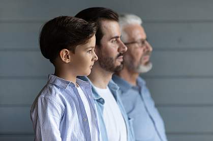 Boy standing in a row with young father behind him and grandfather in back. Boy standing in a row with young father behind him and grandfather in back.