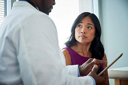 Doctor speaking with a female patient. Doctor speaking with a female patient.