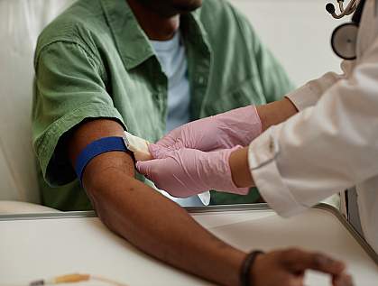 Nurse preparing a patient's arm for a blood test Nurse preparing a patient's arm for a blood test