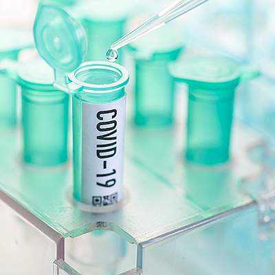 Test tubes with one labeled COVID-19 Test tubes with one labeled COVID-19