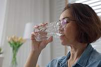 A woman taking a sip of water.