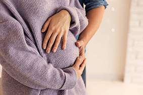 image of a pregnant woman holding her belly.