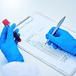 Image of a researcher holding a test tube with a blood sample.