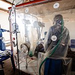 Health workers caring for a patient suspected of having Ebola