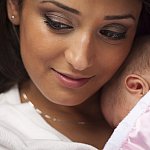 Woman holding newborn. 