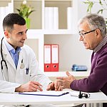 Doctor talking to older male patient.