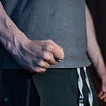 Close-up of a man’s fist with veins showing on arm.